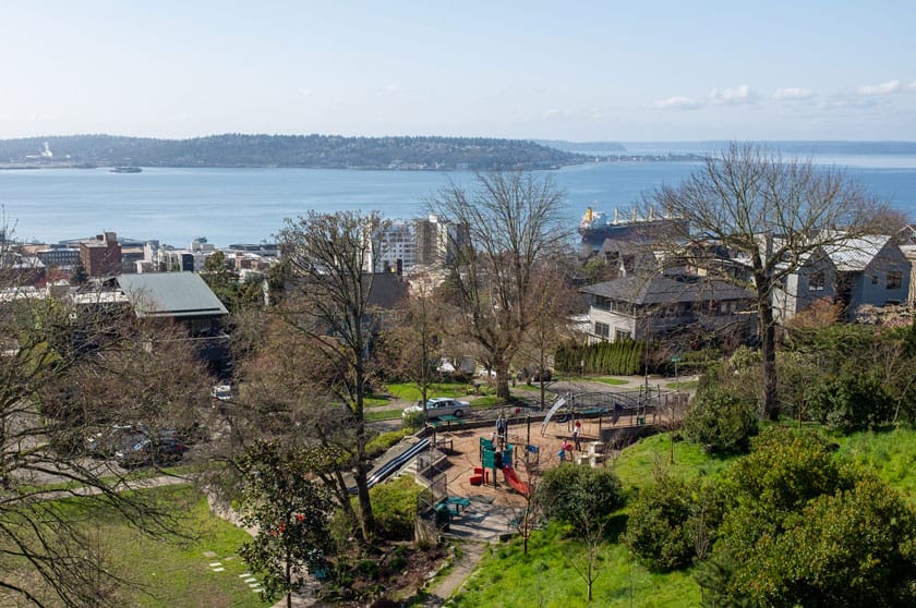 Aerial view of the small neighborhood playground at Kerry Park in Seattle, located just a short walk from the iconic skyline viewpoint. Tucked into a quiet residential area, this kid-friendly spot offers climbing structures and slides, making it a great stop for families visiting Kerry Park with young children.