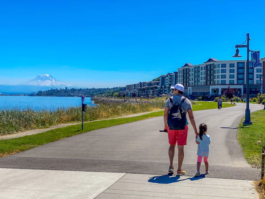 Dad and toddler walking at Point Ruston with Mount Rainier in the background