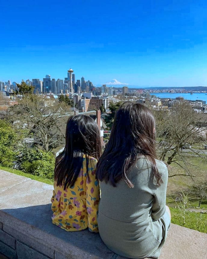 Kids looking out over the Seattle skyline from Kerry Park Viewpoint on a sunny day, taking in the iconic view of the Space Needle, downtown buildings, and Mount Rainier. This small hilltop park is one of Seattle’s most famous photo spots and a kid-friendly stop for families exploring the city.