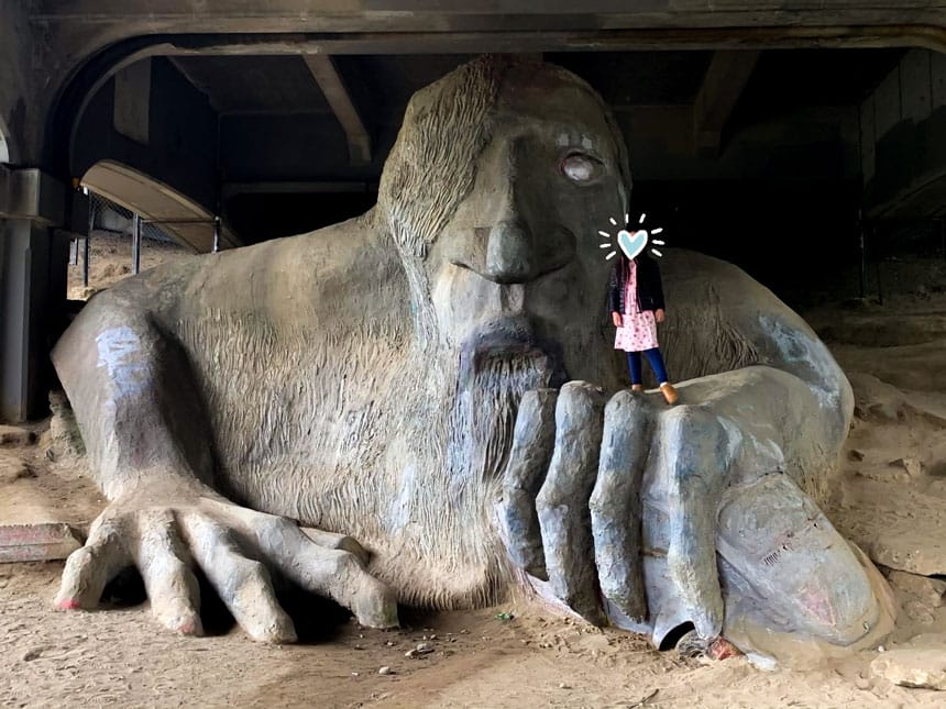 Young Girl Standing on the Huge Fremont Troll Sculpture