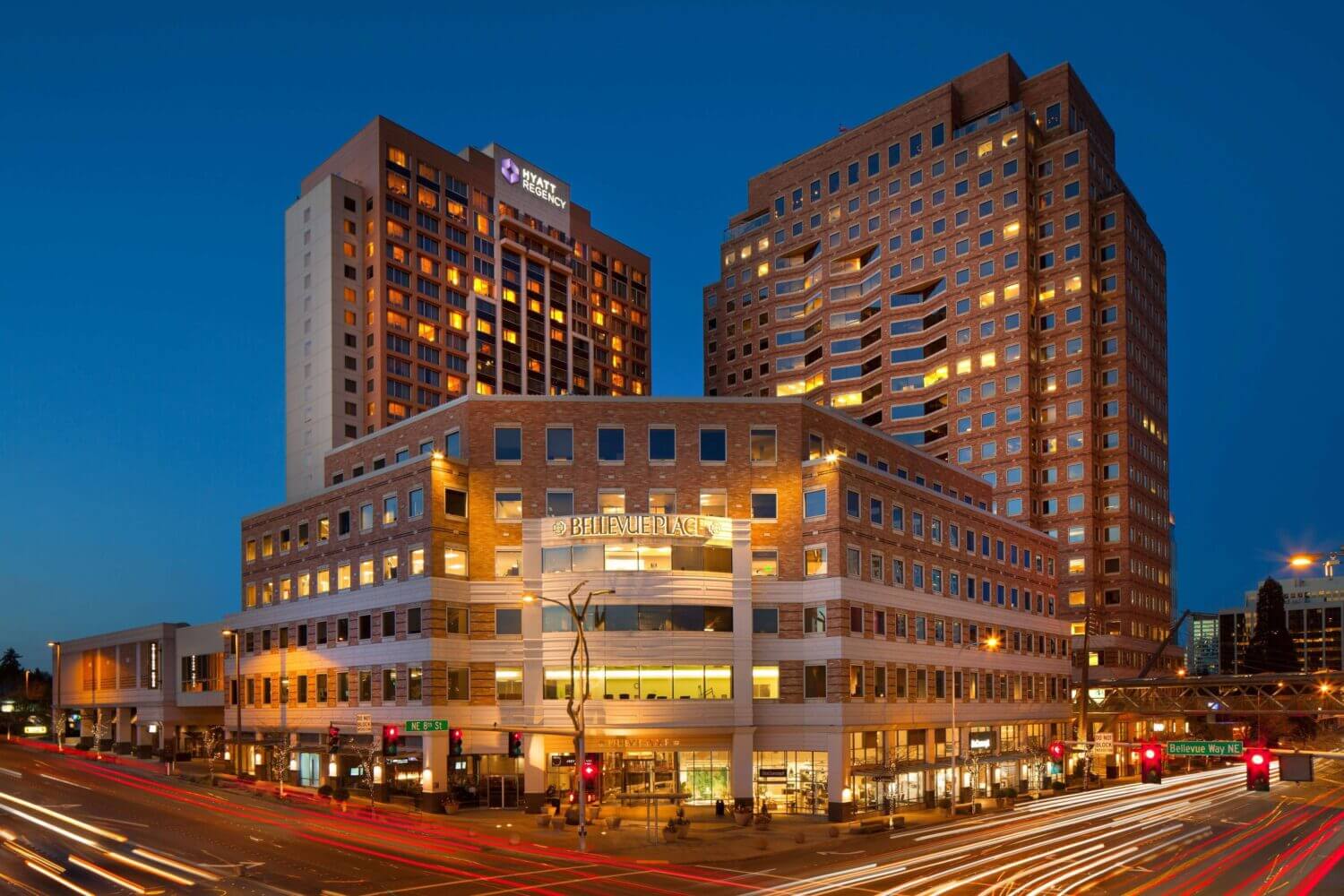 Aerial night view of the Bellevue Hyatt Regency, centrally located in downtown Bellevue. The hotel is beautifully lit against the city skyline, making it a standout choice in our blog on the best places to stay with kids in Bellevue.