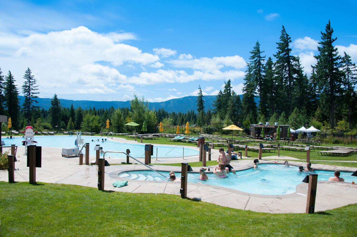 Suncadia Resort indoor and outdoor pools for guests at the swim and fitness center, offering fun activities for kids.