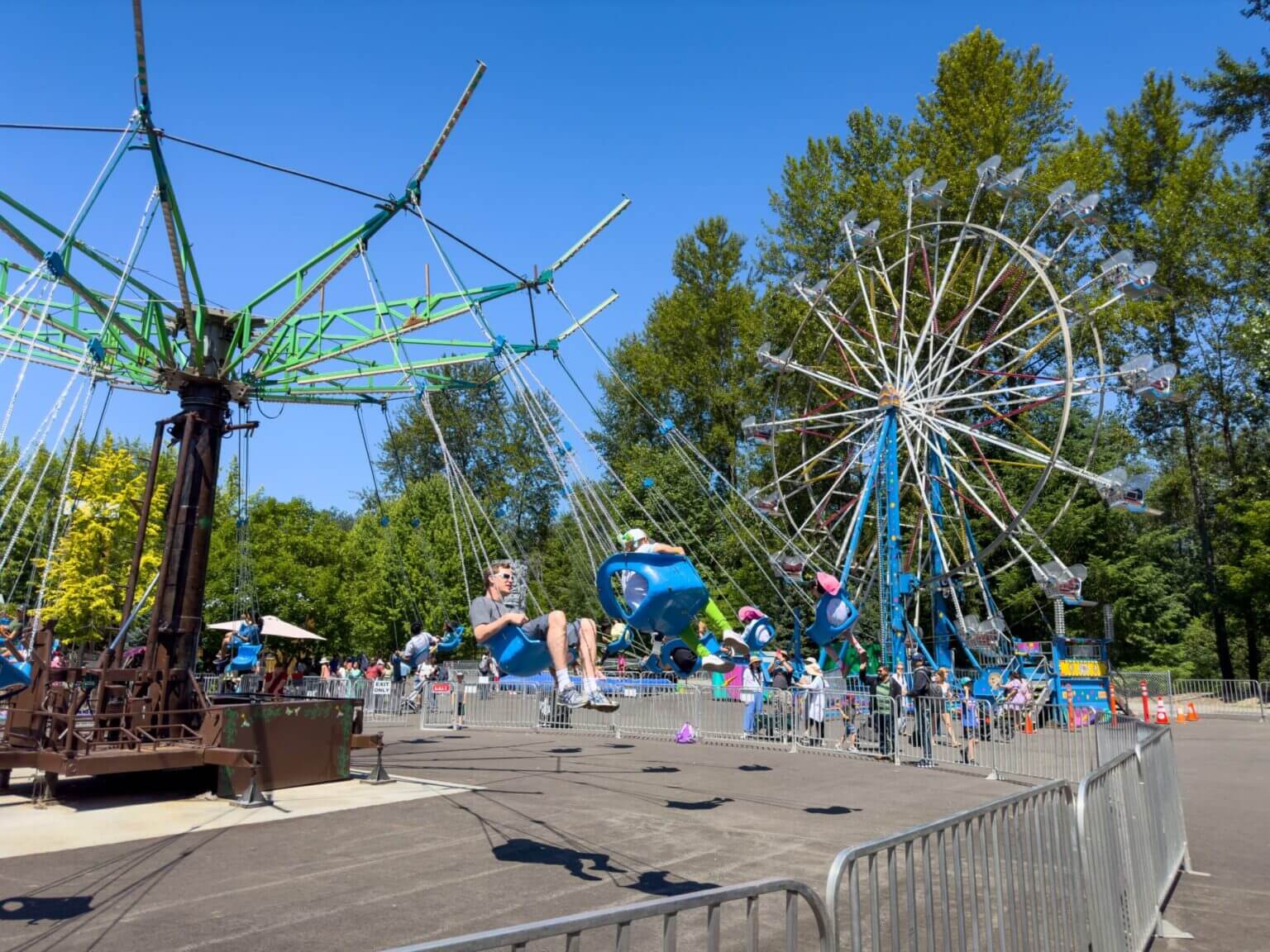 A view of carnival rides like the ferris wheel and big swing seen at Remlinger Farms. Carnation, Washington