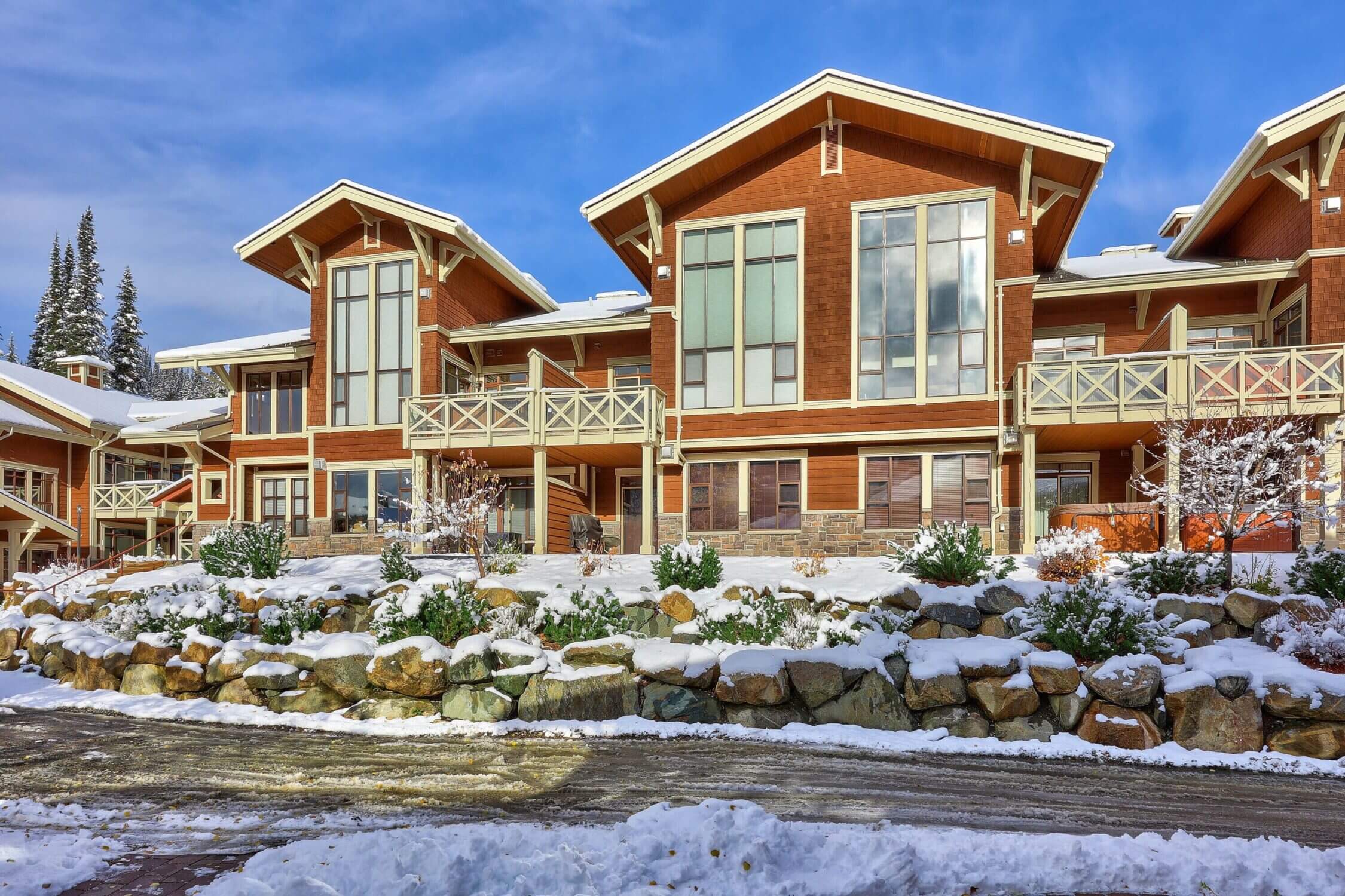 The 3-bedroom condo in Stone’s Throw at Sun Peaks offers a cozy, family-friendly retreat nestled right on the edge of the slopes. On this sunny winter day, the snow-covered exterior of the condo sparkles against the clear blue sky—showcasing the perfect alpine escape for families visiting Sun Peaks, Canada. With ski-in/ski-out access, this well-appointed unit allows families to hit the slopes straight from their doorstep. Ideal for winter vacations, the condo features spacious living areas, modern amenities, and a private hot tub, all within walking distance to the village and ski lifts.