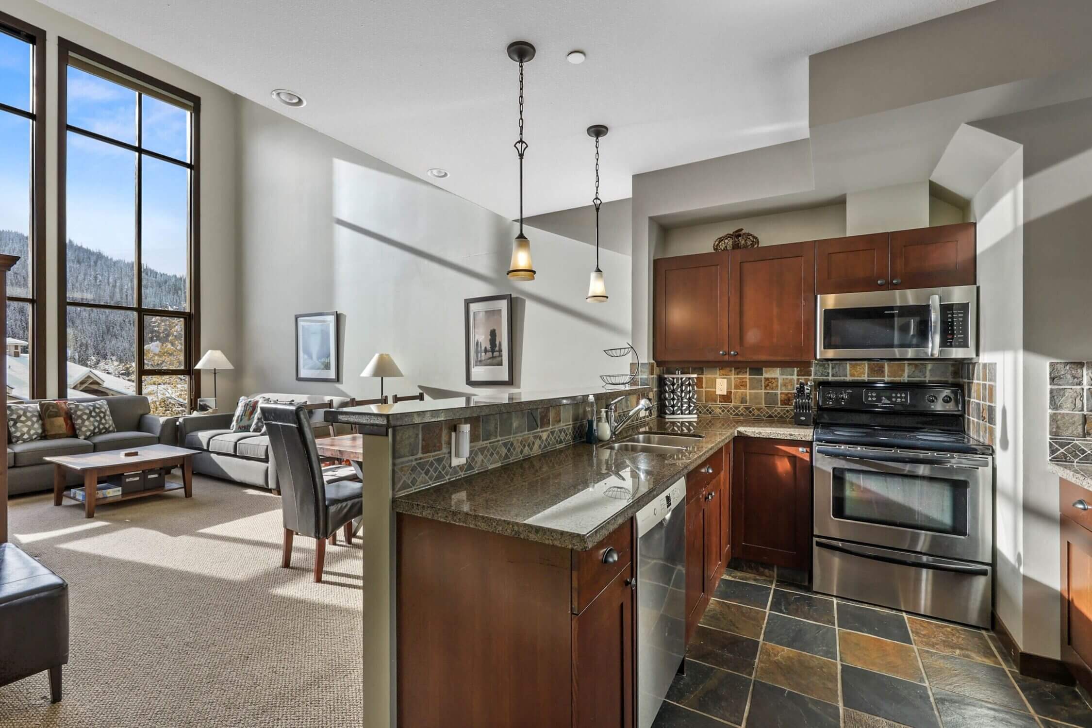 The 3-bedroom condo in Stone’s Throw at Sun Peaks boasts a spacious, fully equipped kitchen that’s perfect for families. Whether you’re preparing a hearty breakfast before hitting the slopes or making a cozy dinner after a day of snow play, this kitchen has everything you need—from a full-size fridge and oven to cookware and utensils. Having a kitchen on-site helps families save money by skipping expensive resort dining, and it’s especially handy for accommodating picky eaters or dietary needs. The open layout makes it easy to cook while staying connected with the rest of the family in the adjoining dining and living areas, making mealtime both convenient and enjoyable.