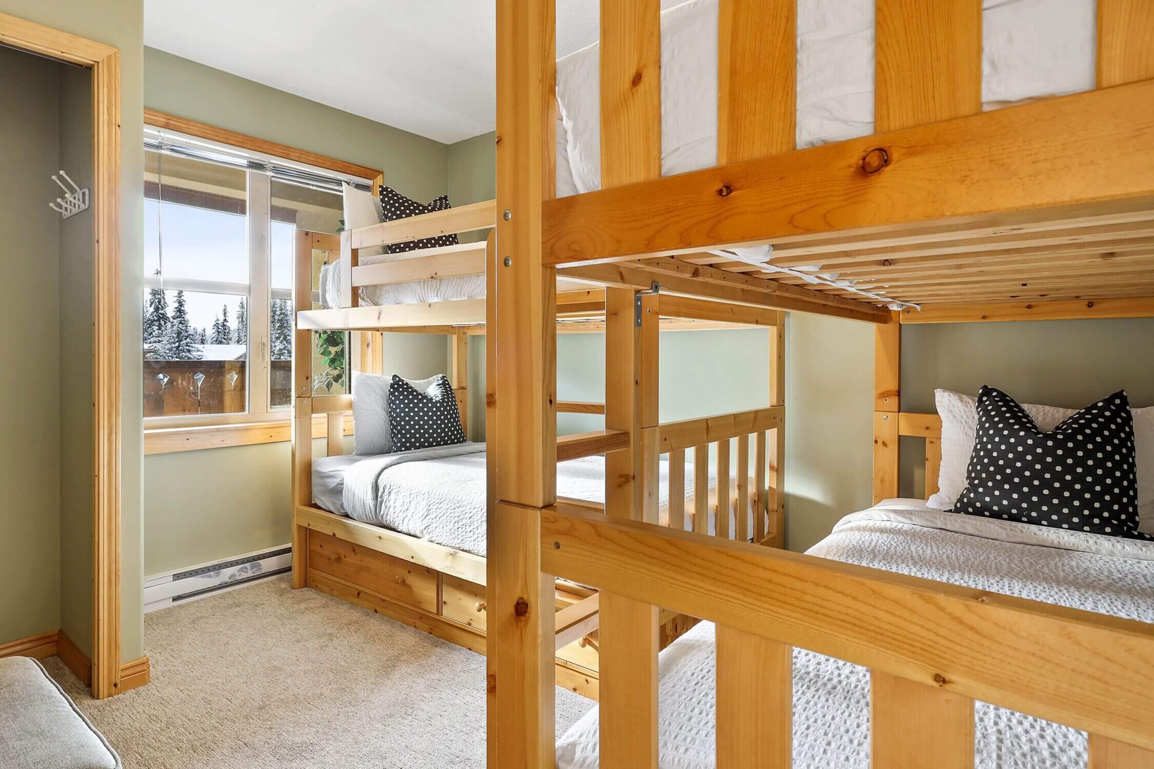 One of our top vacation rentals in Sun Peaks, Canada, Crystal Forest #50 is a 4-bedroom townhome perfect for families. This kid-friendly haven features a dedicated bunkbed room with two sets of bunkbeds—offering a total of four cozy beds that make it ideal for cousins, siblings, or sleepover-style fun. Located just a short walk from the village and lifts, Crystal Forest #50 combines the comforts of home with the charm of a mountain getaway. With a full kitchen, private hot tub, and ample space to relax after a day on the slopes, it’s the perfect base for your next winter family adventure.