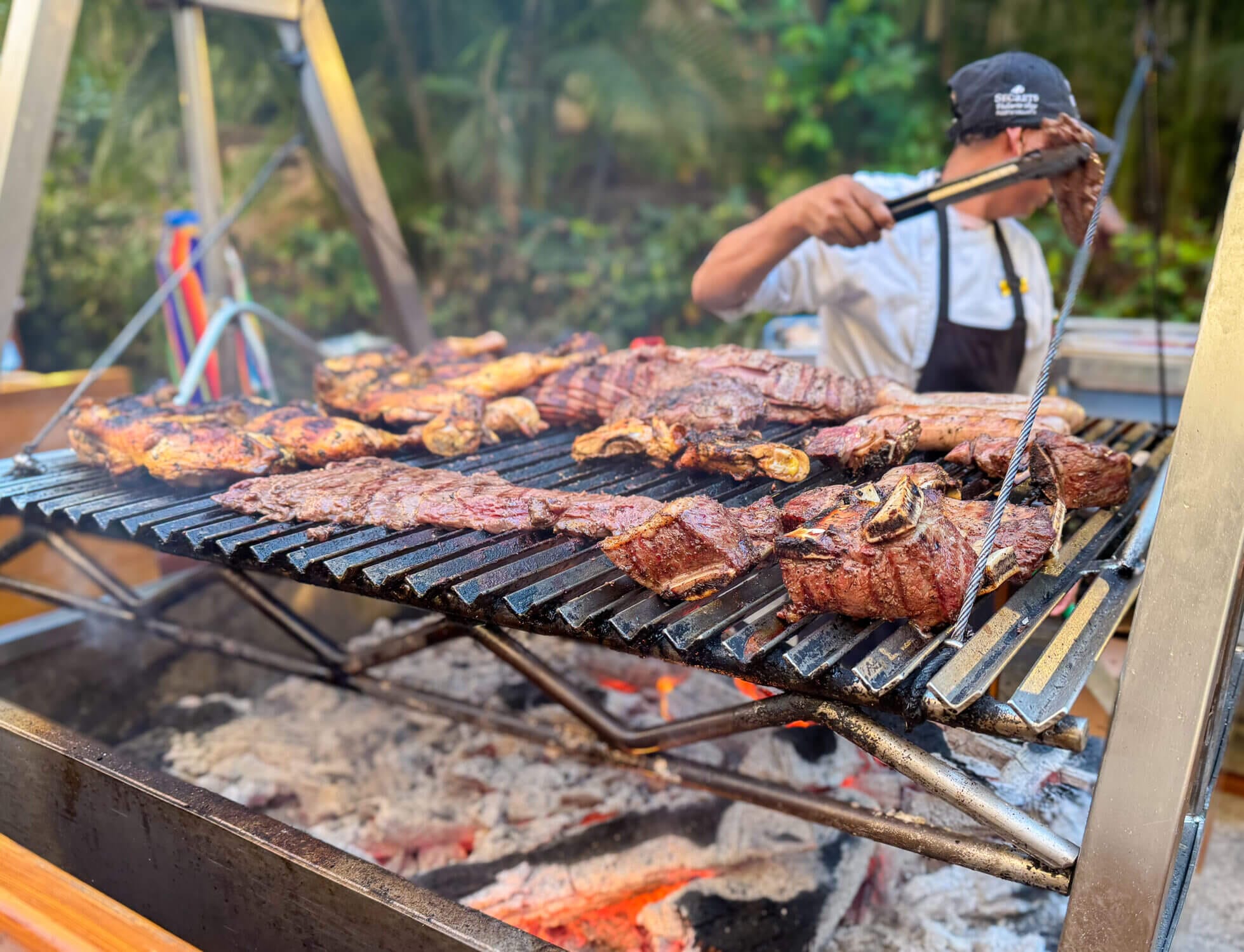 Close-up of the sizzling outdoor BBQ setup at Carnival, the international buffet at Dreams Vallarta Bay Resort. On this themed BBQ night, chefs grill an irresistible spread of meats over charcoal—including juicy short ribs, sausages, chicken, and more. With rotating dinner themes each evening, Carnival keeps things exciting and delicious for families. Whether you’re indulging in fresh seafood one night or Mexican classics the next, the all-you-can-eat format makes it easy to satisfy even the pickiest eaters. The BBQ night is a crowd favorite—especially when you can pile on as many short ribs as your plate will hold!