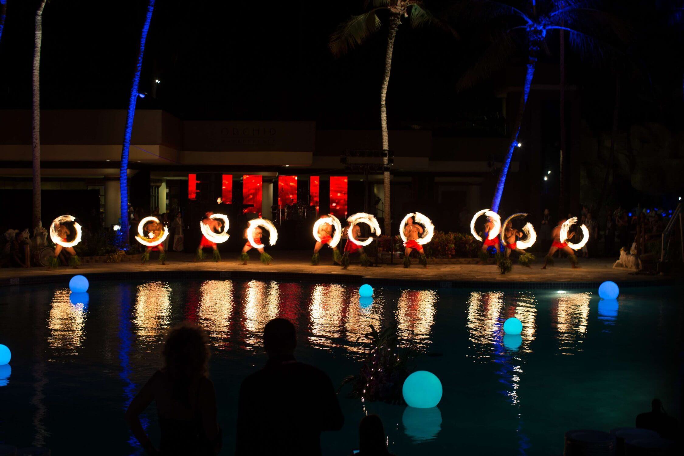 Fire dancer performing under the stars at the Hilton Waikoloa Village Legends of Hawaii Luau on the Big Island. This captivating evening show features traditional Hawaiian music, hula dancing, storytelling, and the dramatic fire dance finale—making it a top family-friendly cultural experience in Kona that kids and adults will remember.