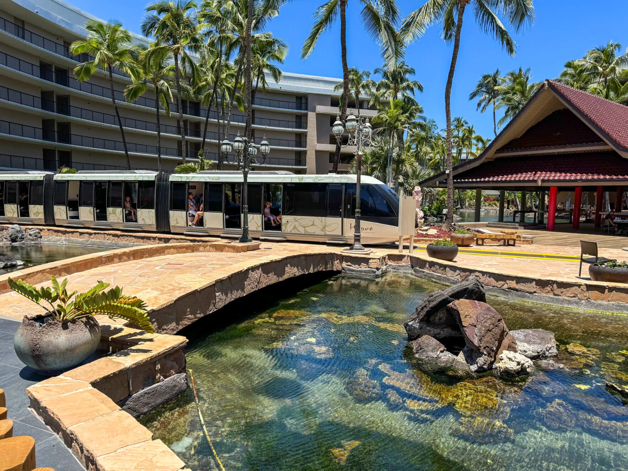 Monorail at one of the scenic stops inside the expansive Hilton Waikoloa Village on the Kona side of the Big Island. Featured in our Big Island family guide, this resort is a must-visit even if you’re not staying overnight. Families can explore the beautifully landscaped grounds, admire Hawaiian sculptures and art, watch live dolphins at Dolphin Quest, and enjoy a fun monorail ride that transports guests across the massive oceanfront property—making it an unforgettable stop with kids.