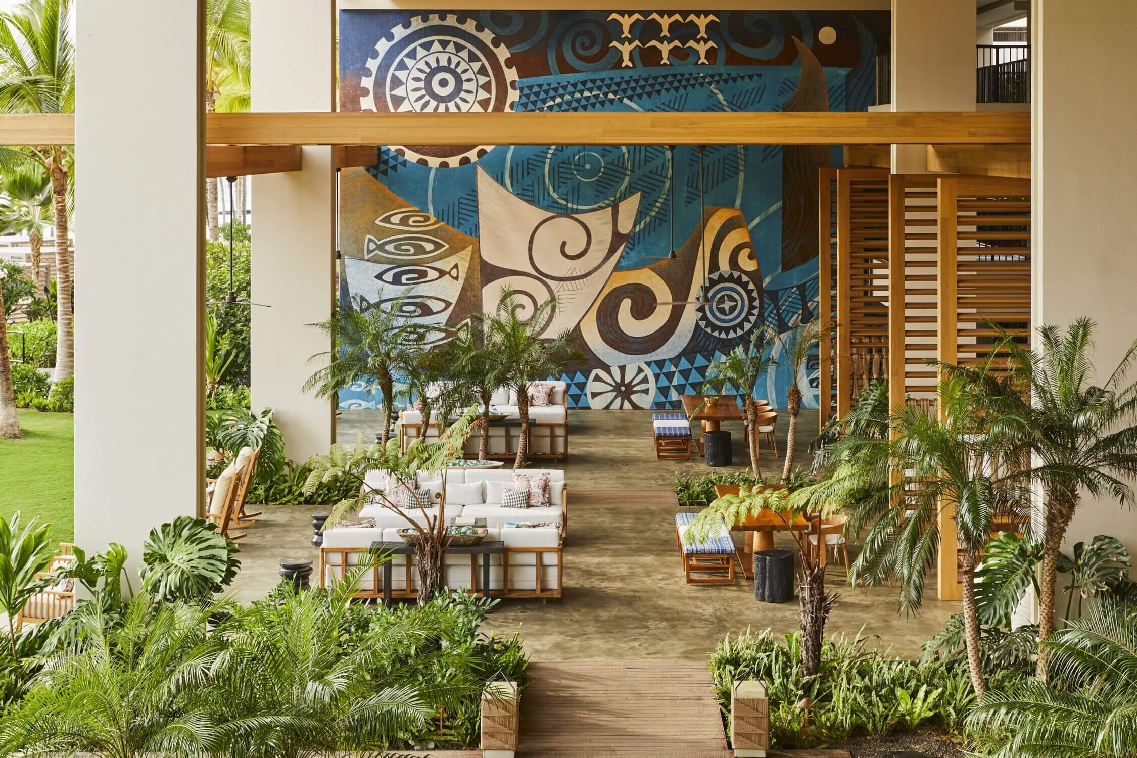 Beautiful lobby at the Mauna Lani Resort on the Kona side of the Big Island, featuring open-air architecture, elegant Hawaiian design, and a stunning mural painting that celebrates island culture. This serene and upscale entrance sets the tone for a luxury family vacation, blending modern comfort with traditional Hawaiian art and ambiance.