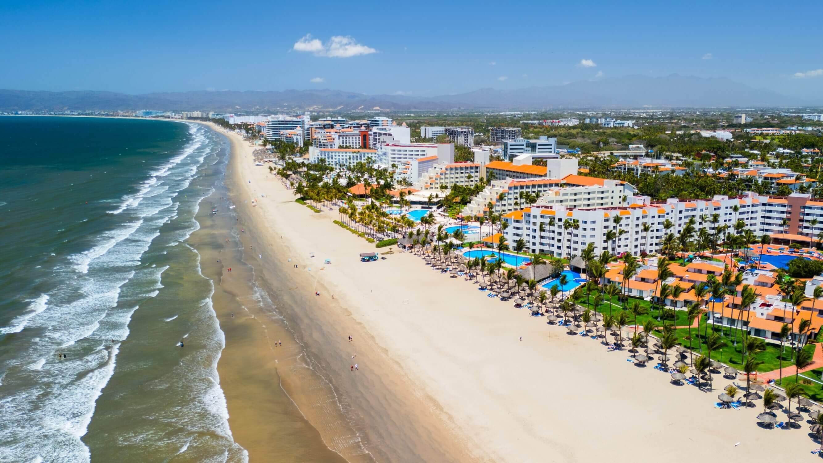 An aerial view of Nuevo Nayarit Beach reveals miles of golden sand, gentle waves, and palm-lined resorts stretching along the Pacific coast. Just north of Puerto Vallarta, this serene beach is a favorite for families with kids thanks to its wide, walkable shoreline, calm waters, and relaxed atmosphere. It’s the perfect place for a family beach stroll, sandcastle building, and shell collecting. Nearby, families can also enjoy beachfront dining, kid-friendly resort pools, and local wildlife tours like dolphin watching or sea turtle releases. Nuevo Nayarit Beach offers a quieter, more laid-back alternative to the bustle of downtown while still being close to all the family-friendly attractions Puerto Vallarta has to offer.