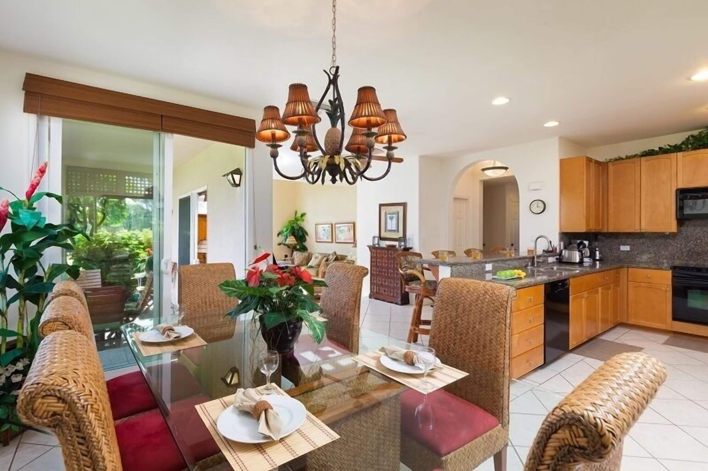 Interior view of the kitchen and dining area at Waikoloa Colony Villas on the Kona side of the Big Island. This open-concept layout features a full kitchen with modern appliances and a family-sized dining table—perfect for cooking meals and enjoying family time while on vacation. Highlighted in our blog as a great stay for families, especially for those traveling with kids and grandparents.