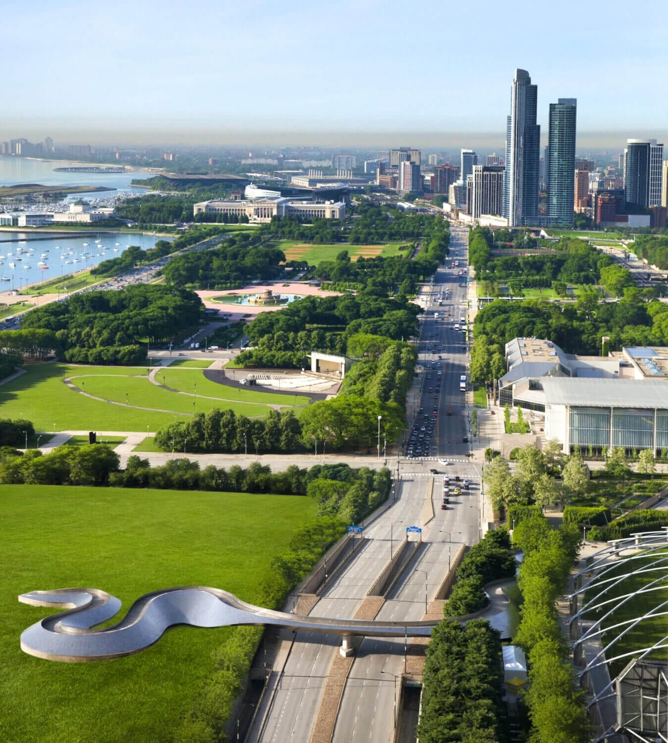 Scenic view from a guest room at the Fairmont Chicago overlooking Millennium Park, with sights of green park spaces, the city skyline, and iconic Chicago landmarks.