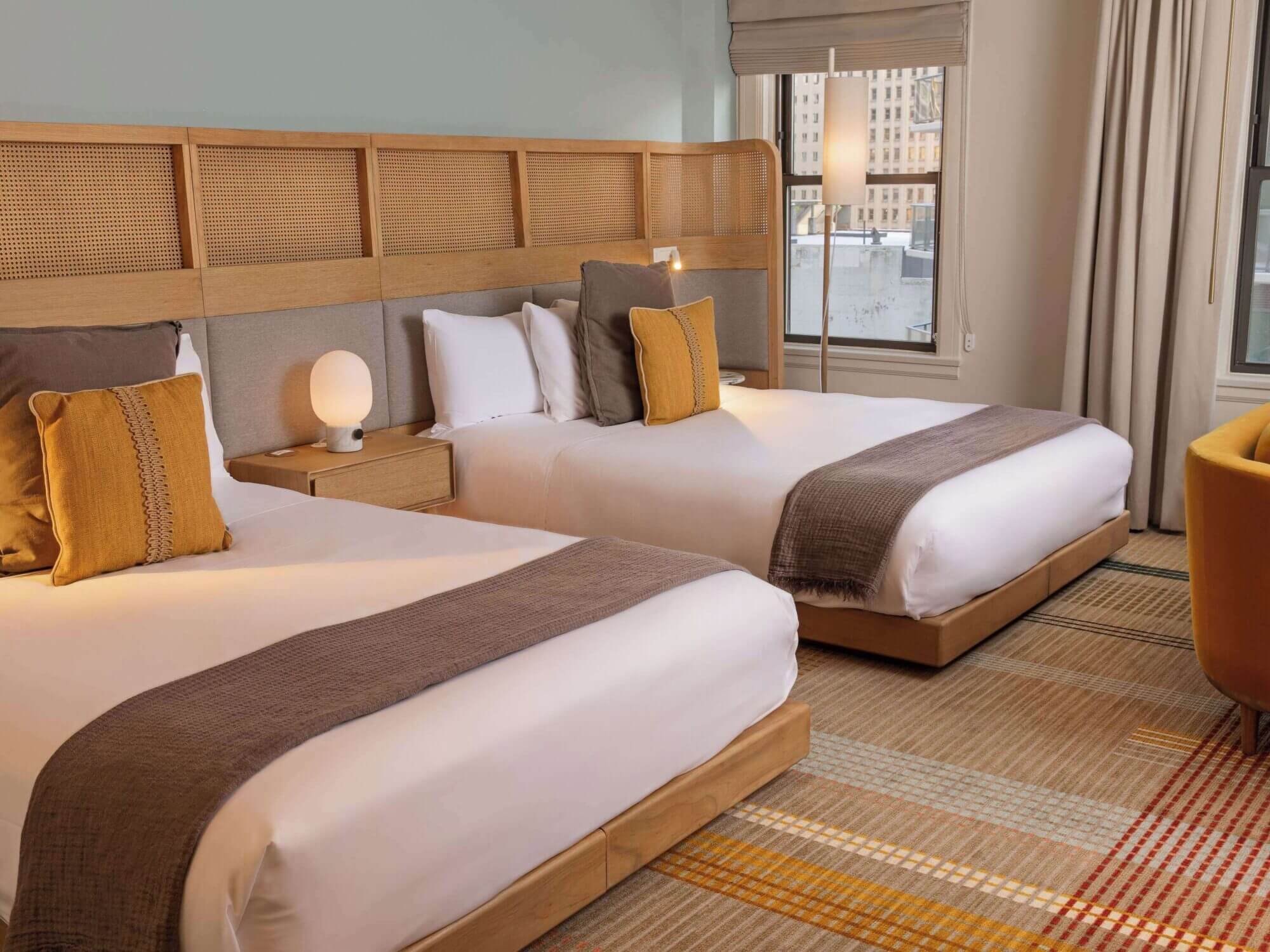 Interior view of a 2-queen bed room at Hotel Ändra in Seattle’s Belltown neighborhood, a stylish boutique hotel featured in our guide to the best places to stay with kids in Seattle.