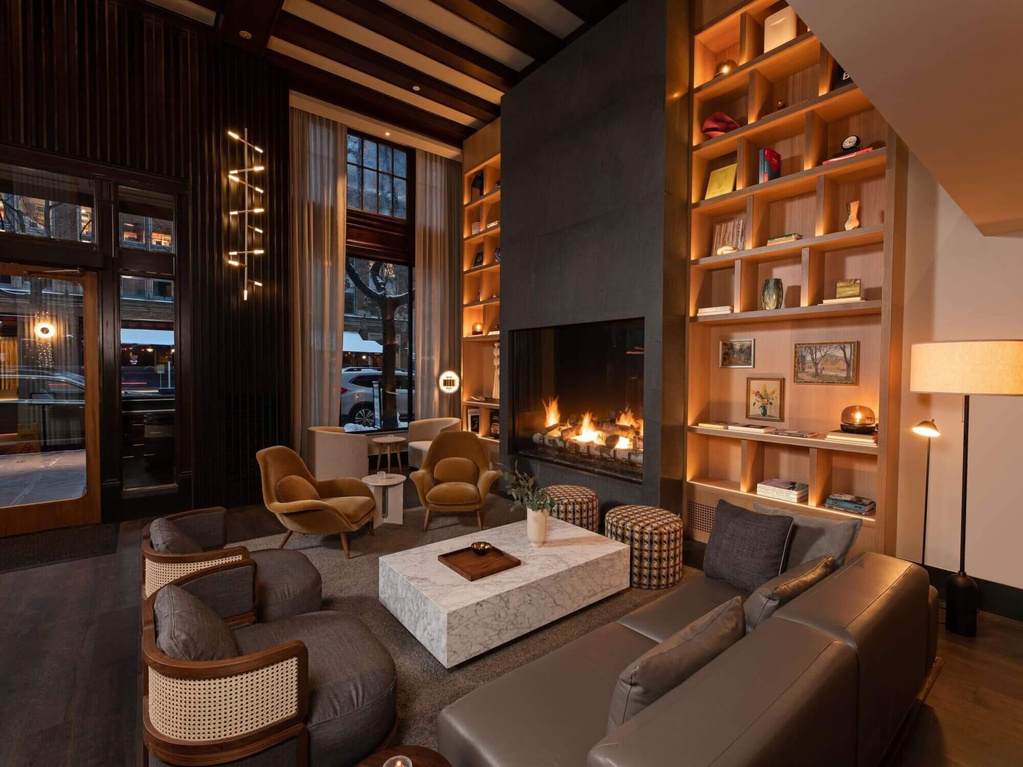 Stylish boutique lobby at Hotel Ändra in Seattle’s Belltown, featuring warm wood tones, modern seating, and a cozy fireplace—highlighted in our guide to the best places to stay with kids in Seattle.