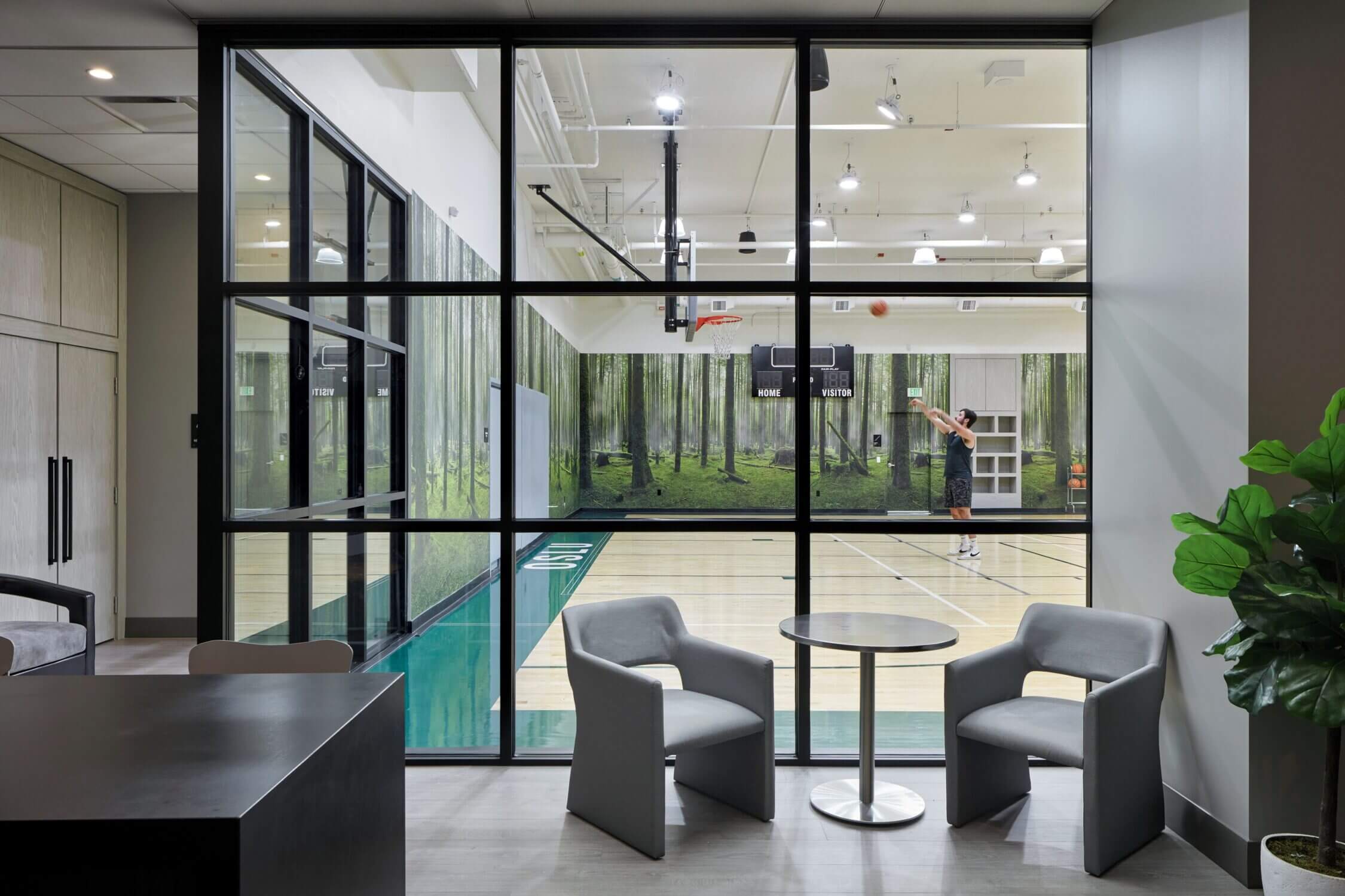 Indoor basketball court at Level Seattle Downtown in South Lake Union, a unique family-friendly hotel feature where kids and adults can shoot hoops and stay active during their stay.