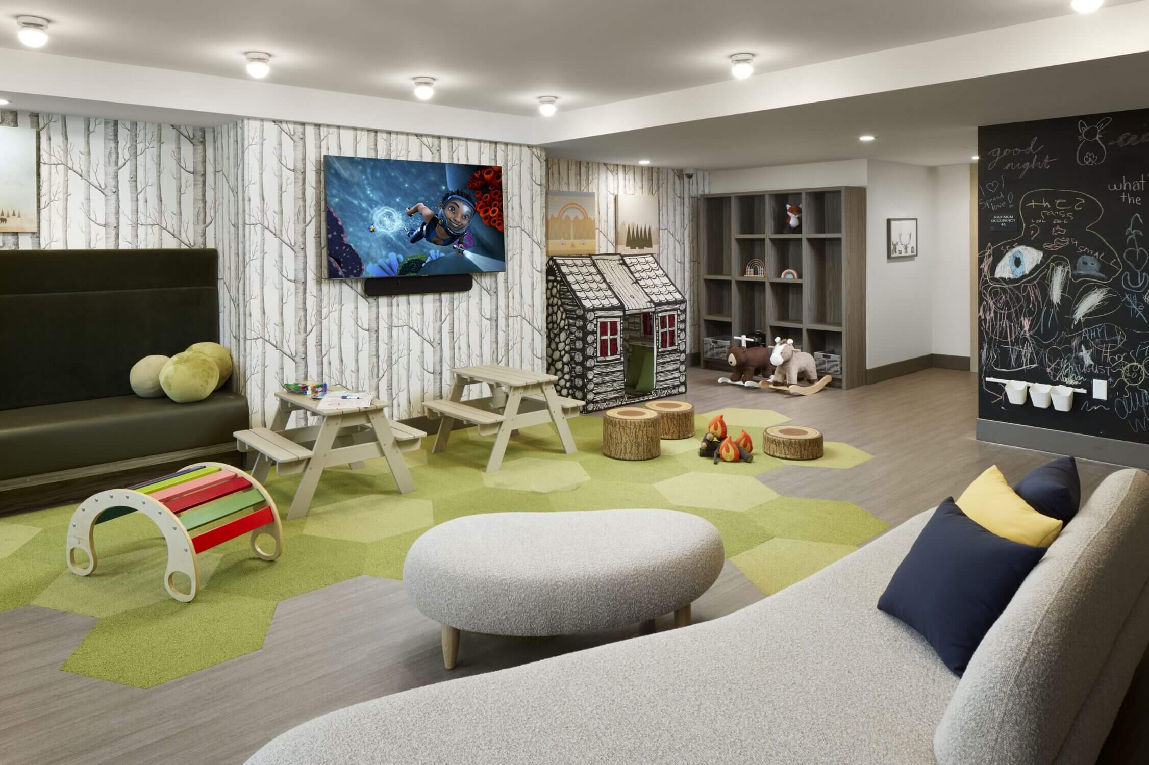 Indoor kids play area at Level Seattle Downtown in South Lake Union, featuring colorful mats, toys, and climbing structures—perfect for young children to burn energy while staying at this family-friendly hotel.